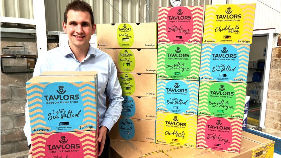 James Taylor, Managing Director of Taylors Snacks, holding new boxes of Taylors crisps, as part of the Mackie's Crisps rebrand.
