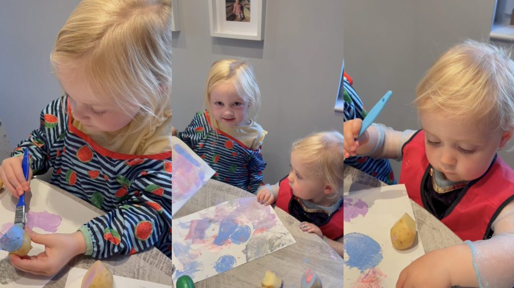 Two girls preparing their #TattieArtChallenge entries, by painting with potatoes.