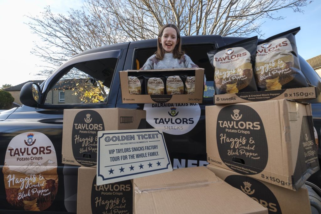 Grace from Edinburgh, with her haggis crisps, leaning out of a haggis taxi.