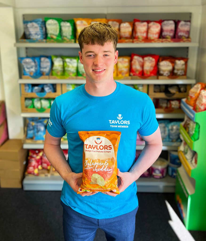 Josh Marchbank, the B-Corp certification project lead, holding his favourite flavour of Taylors crisps - Jalapeno & Mature Cheddar