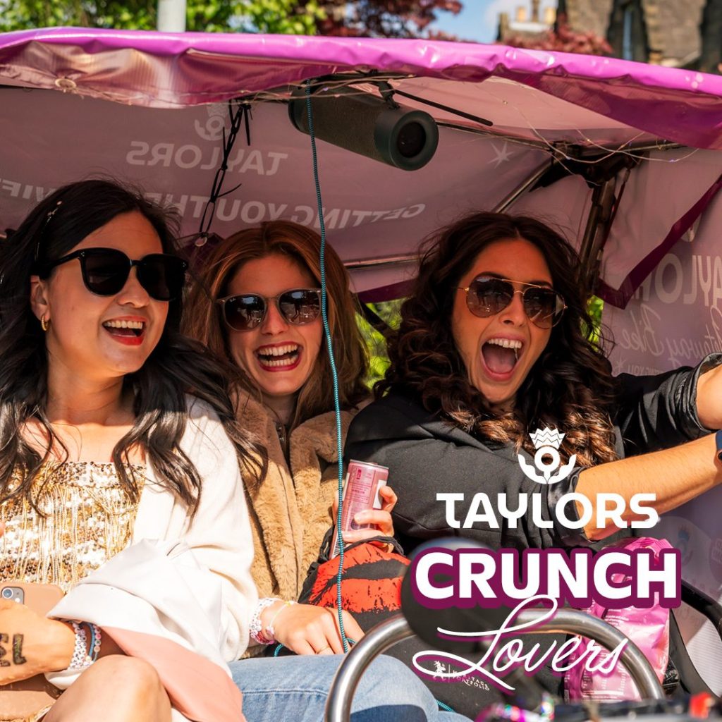 Three passengers in the Taylors rickshaw, in Edinburgh. Sampling Taylors Limited Edition Crisps.